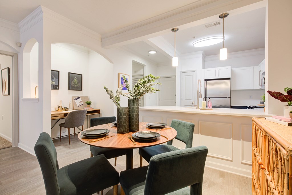 a dining room with a table and chairs and a kitchen