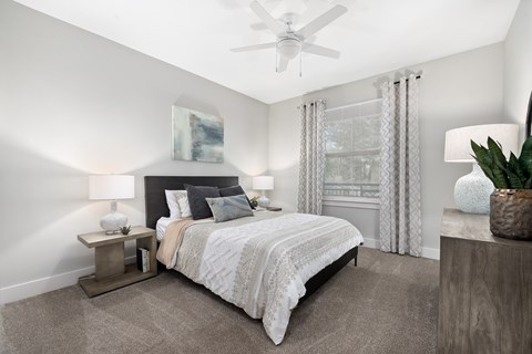 a bedroom with a bed and a ceiling fan
