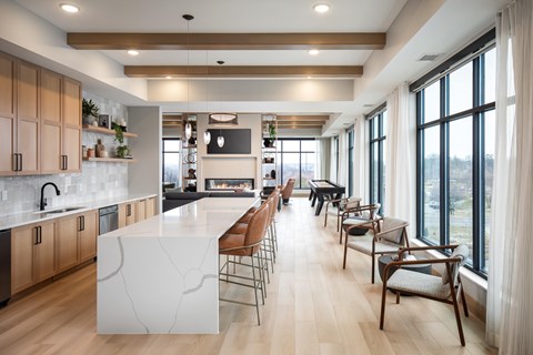 A modern kitchen with wooden cabinets and a marble island.