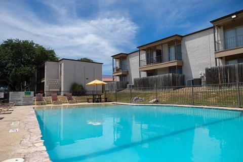 A swimming pool in front of apartment buildings.