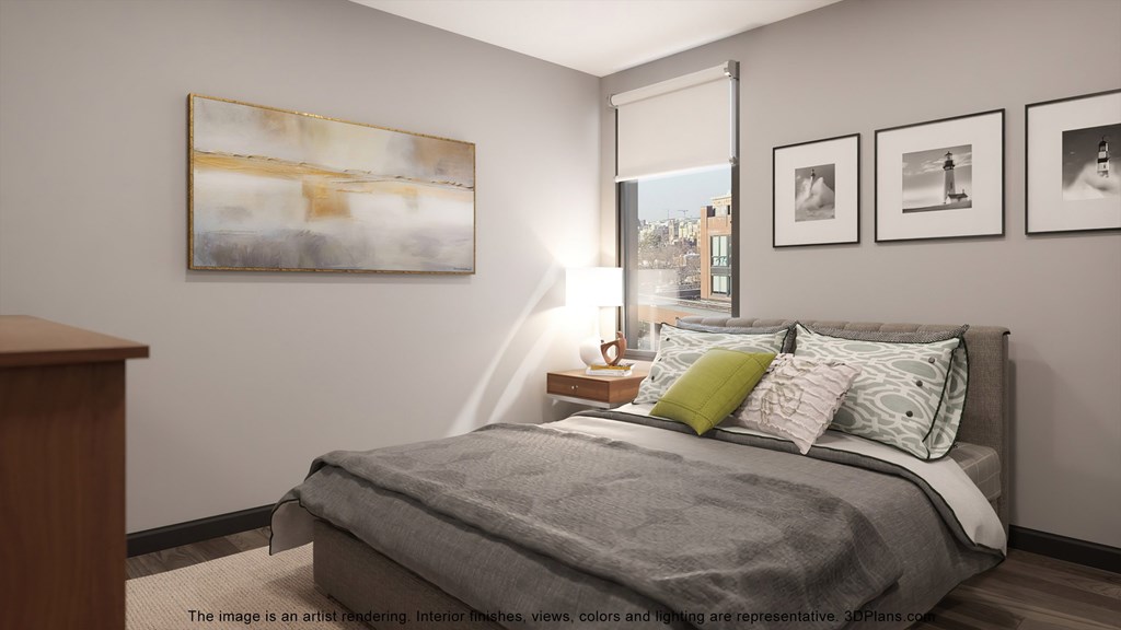 a bedroom with a bed and pictures on the wall