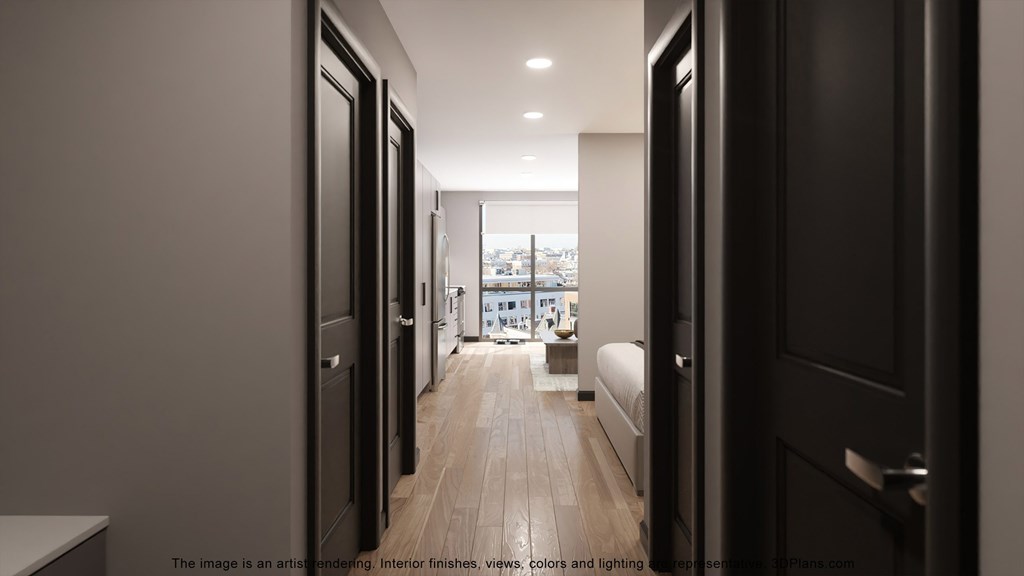 a hallway with black doors leading to a bedroom and a living room