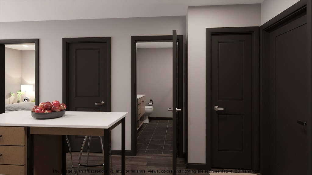 a room with black doors and a white table with fruit on it