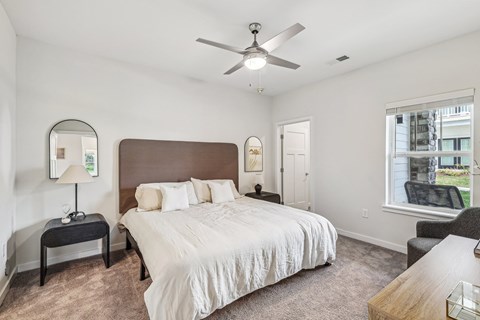 a bedroom with a large bed and a ceiling fan