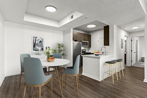 A modern kitchen with a dining table and chairs.