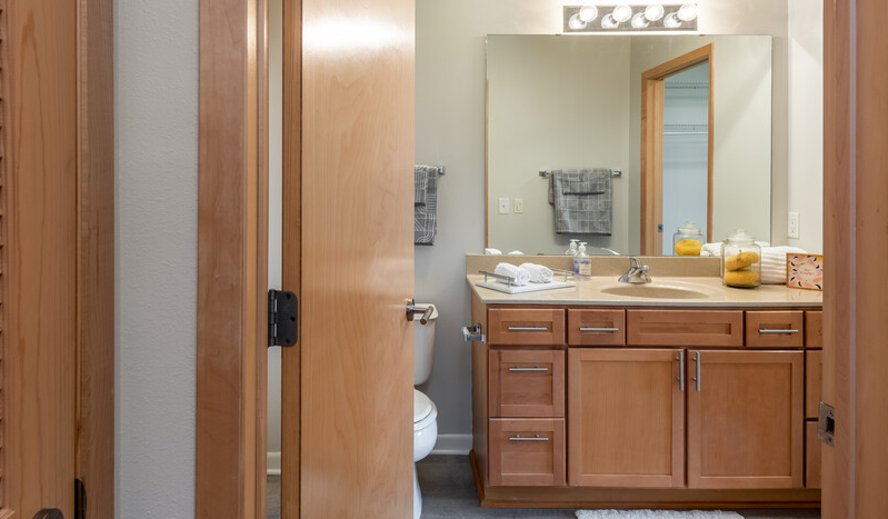 a bathroom with a sink toilet and mirror
