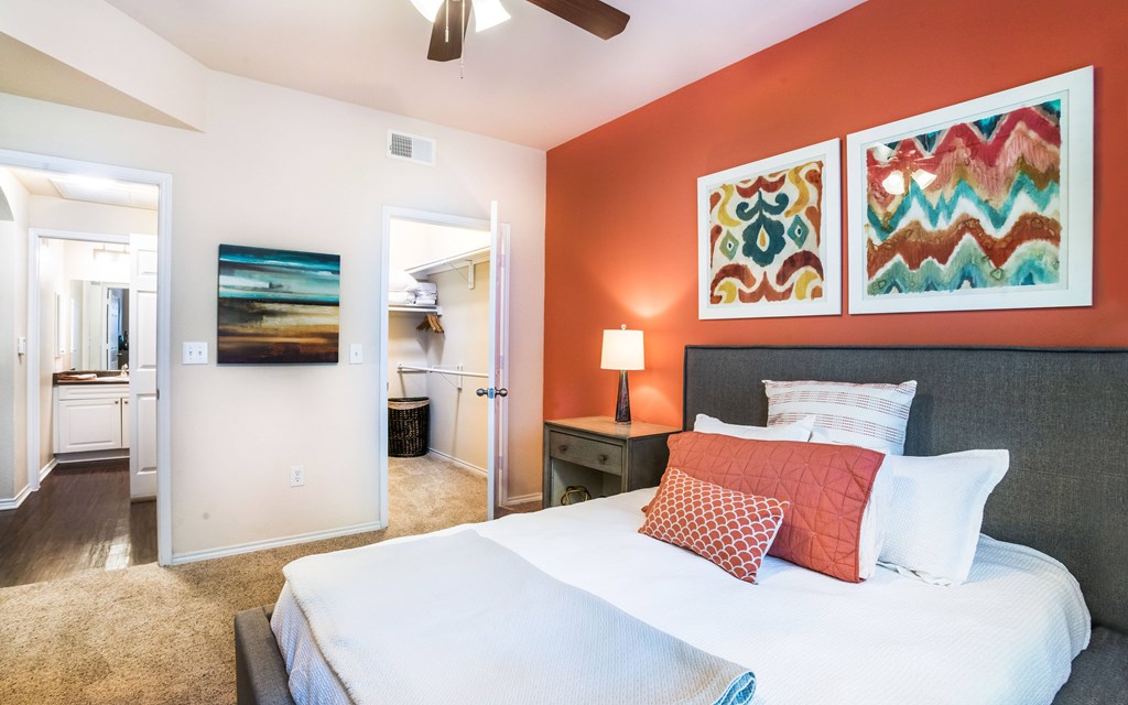 a bedroom with a bed and a ceiling fan