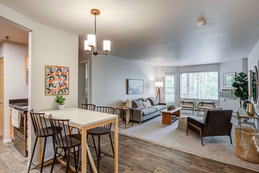 an open living room and dining room with a table and chairs