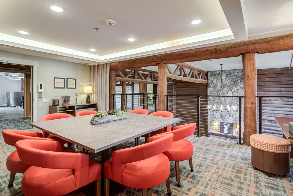 a dining room with a wooden table and chairs