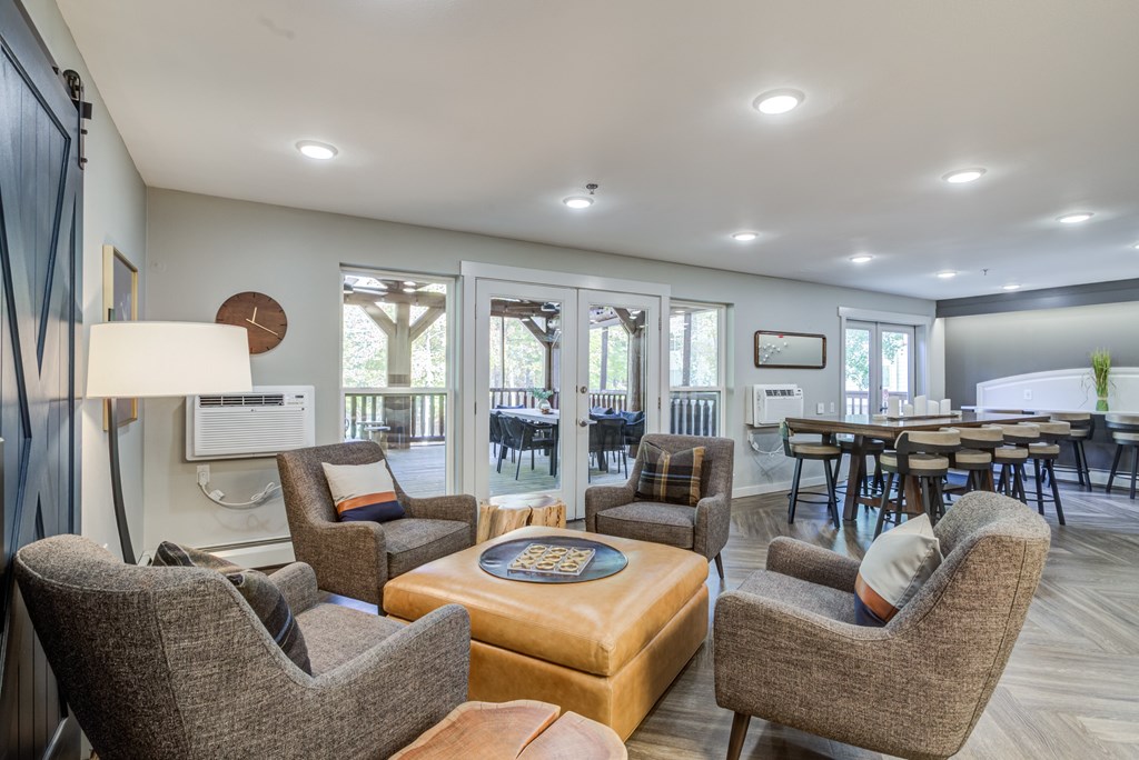a living room with couches and chairs and a dining room with tables