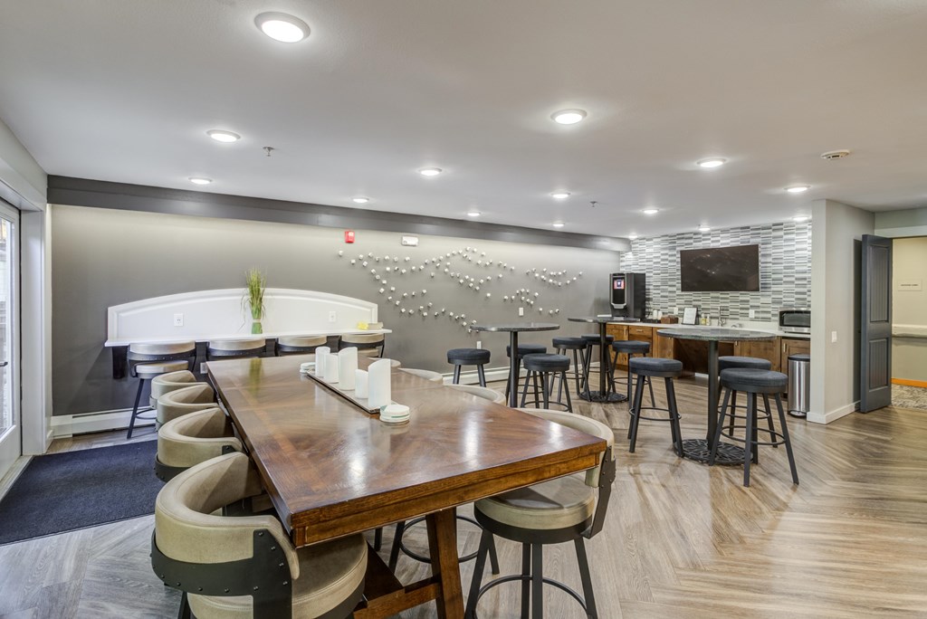 a dining room with tables and chairs and a bar and a television