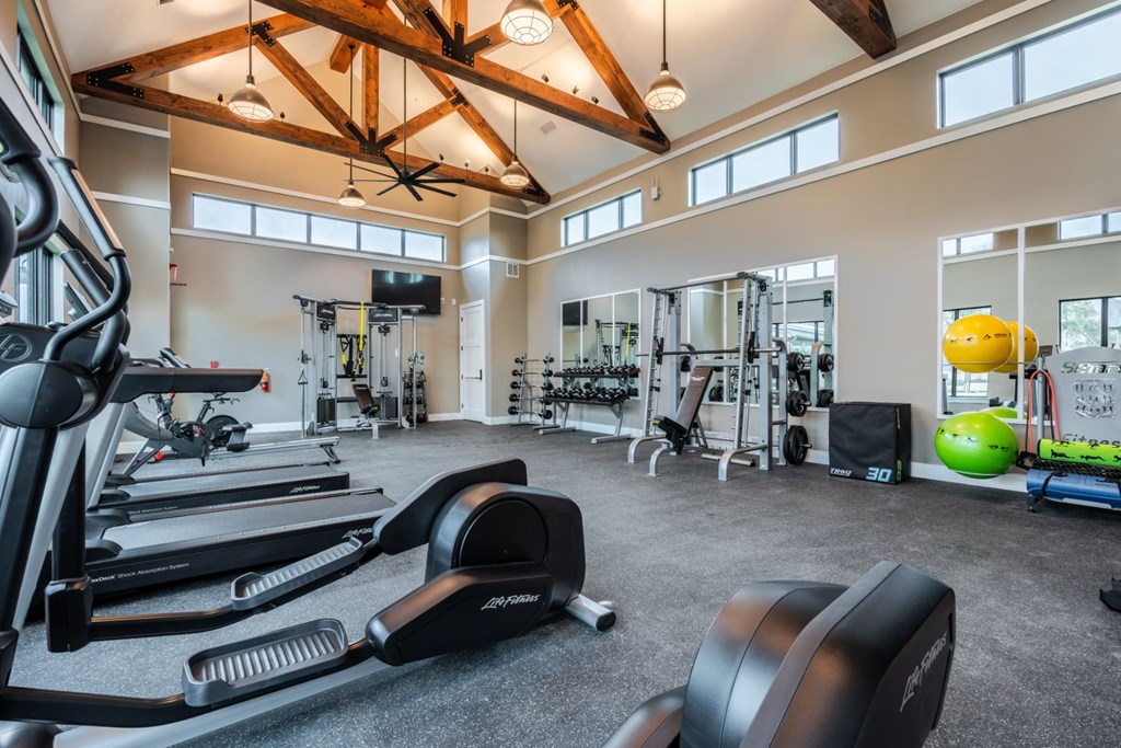a spacious fitness center with treadmills and other exercise equipment