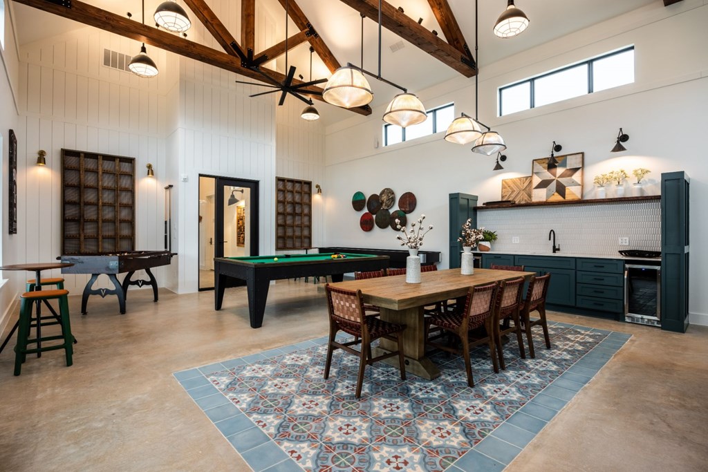 a games room with a pool table and ping pong table