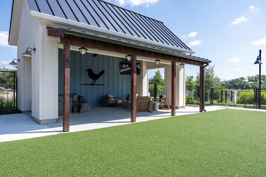 a shed with a metal roof and wood posts