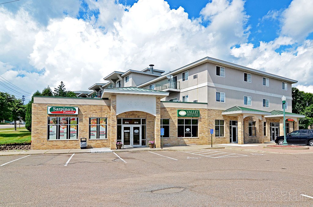 the front of a hotel with a parking lot
