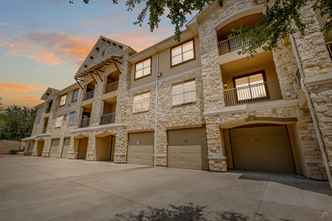 A large stone building with multiple garage doors.