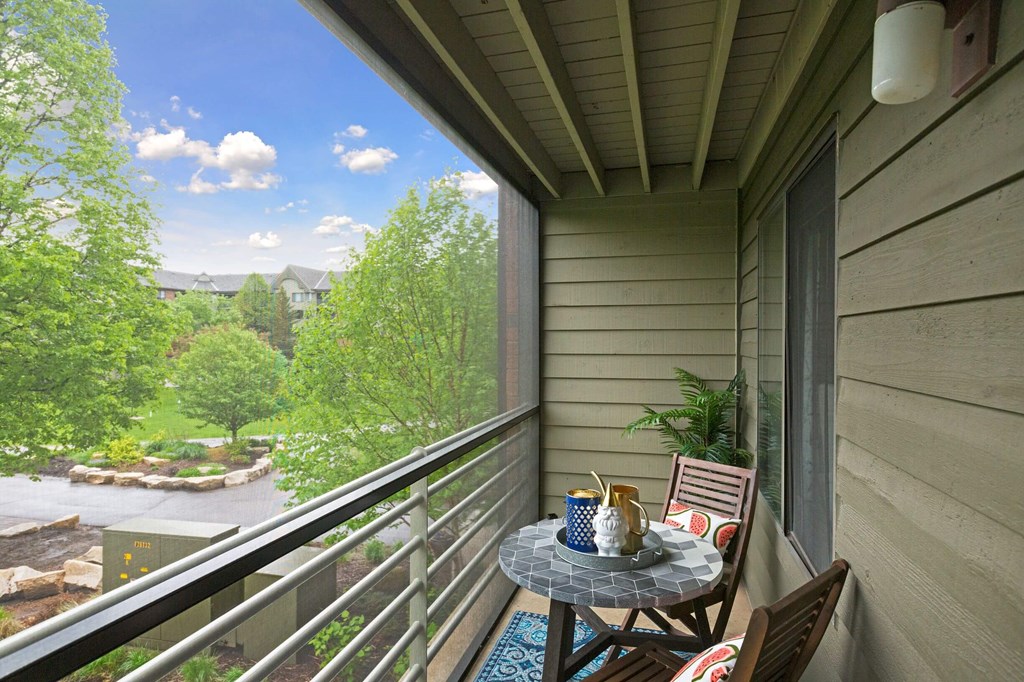 a patio with a table and chairs on a balcony