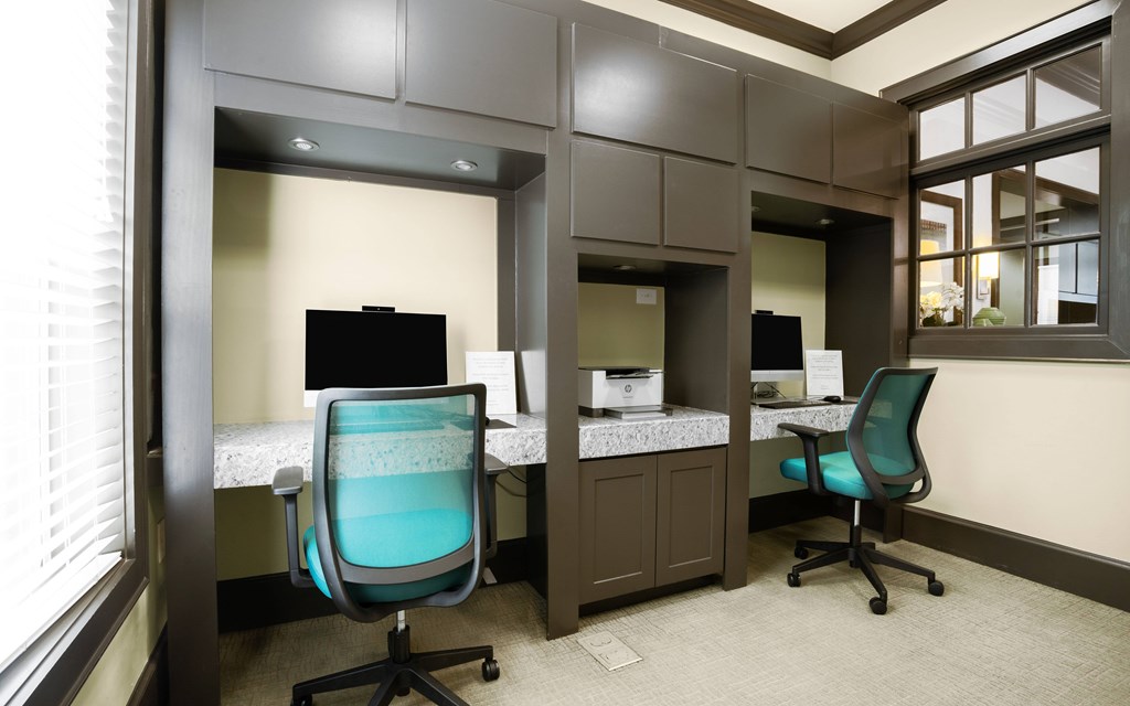 a small office with two desks and two chairs