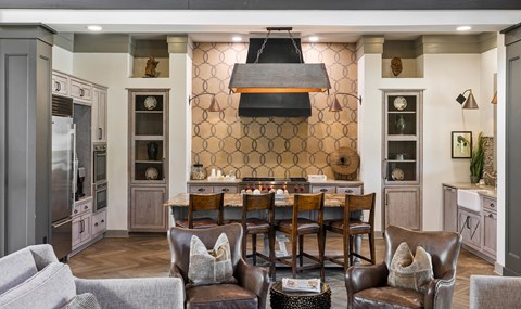 A kitchen with a table and chairs in the middle.