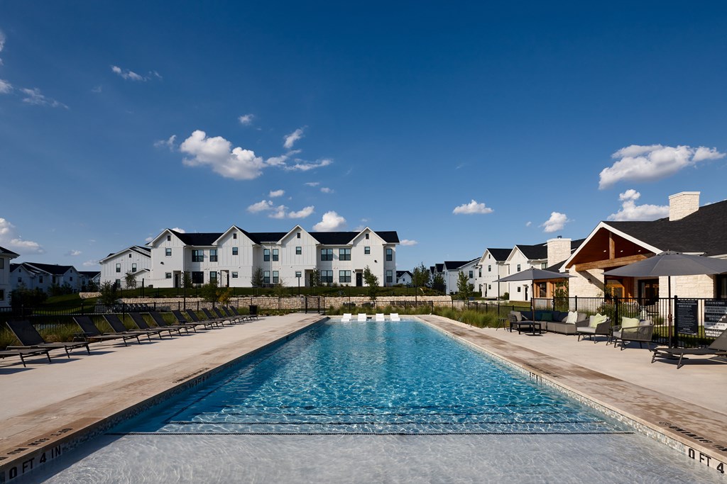 white buildings with pool & blue sky
