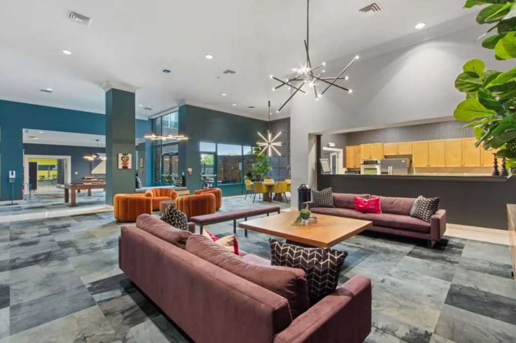 A modern living room with a large red sofa and a coffee table.