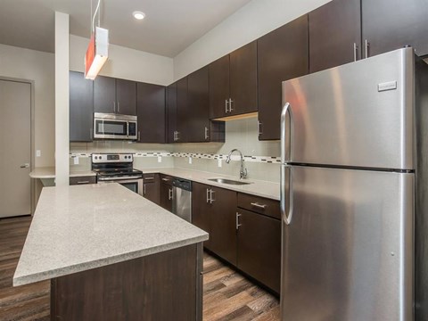 a kitchen with stainless steel appliances and a counter top