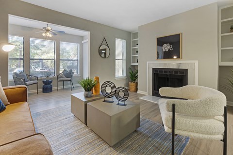 A living room with a fireplace and a chair.