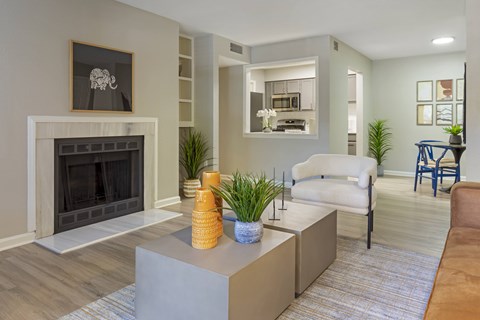 A living room with a fireplace and a chair.
