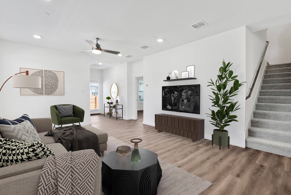 a living room with white walls and hardwood flooring