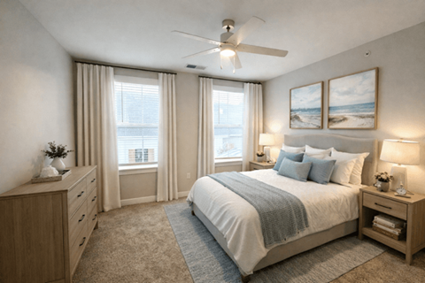 A bedroom with a large bed, a dresser, and a window with curtains.