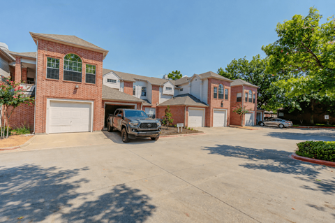 A residential area with a house and a parked car.