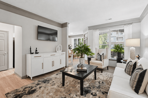 A living room with a black coffee table and a white sofa.
