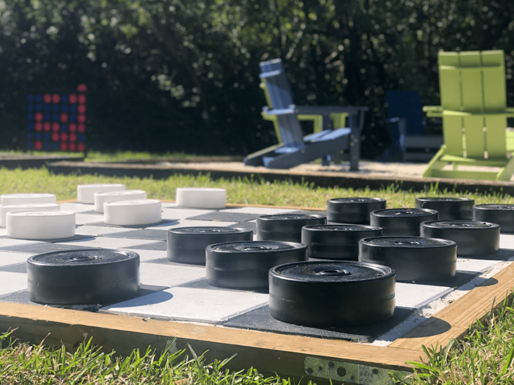 a chess board in the grass with tires on it