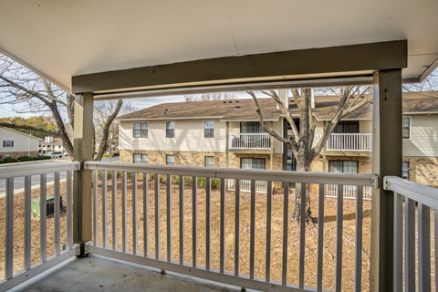 A view from a balcony looking at apartment buildings.