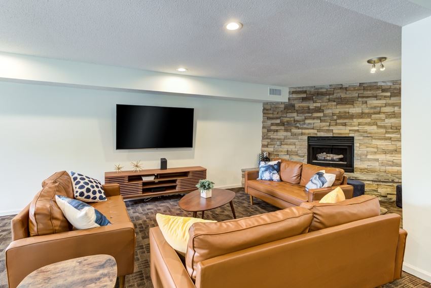 a living room with couches a coffee table and a fireplace