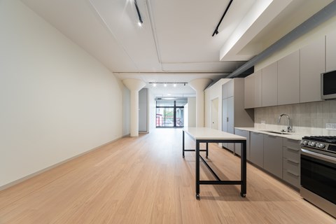 A kitchen with a table and a stove.