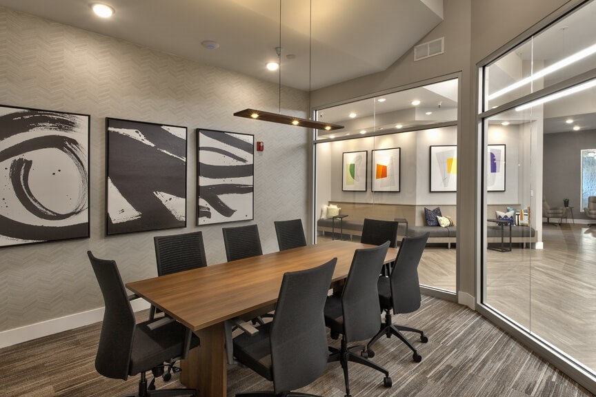 a conference room with a wooden table and chairs