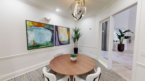 a dining room with a wooden table and chairs