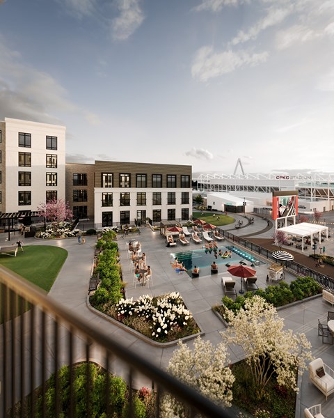 A view of a courtyard with a pool and a building in the background.
