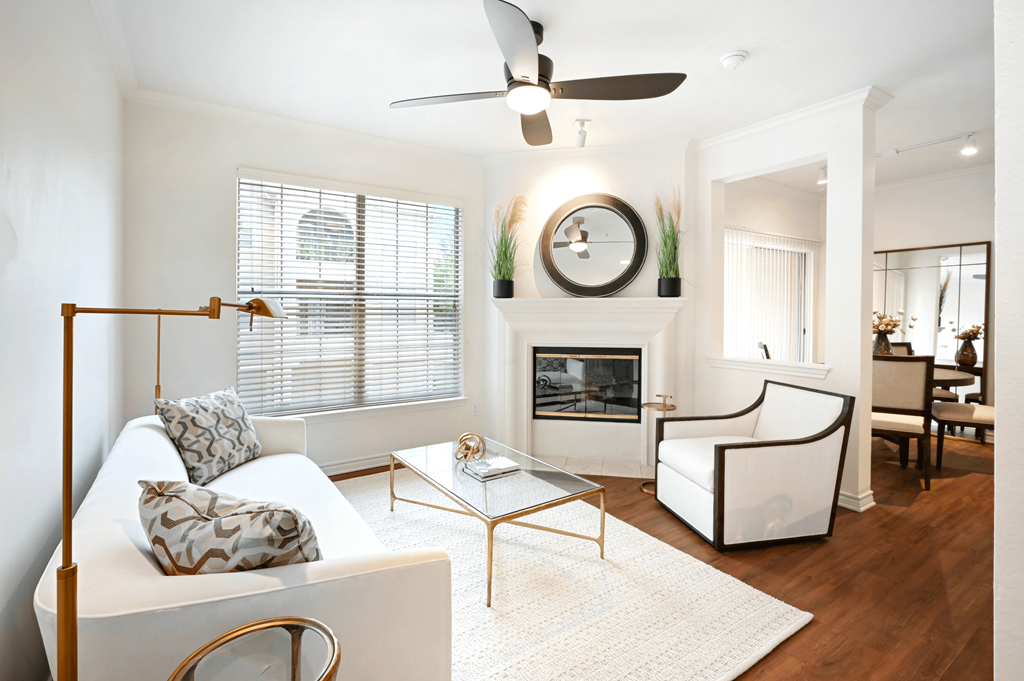 a living room with a white couch and a fireplace