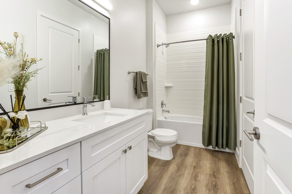 a bathroom with white cabinets and a shower and a toilet