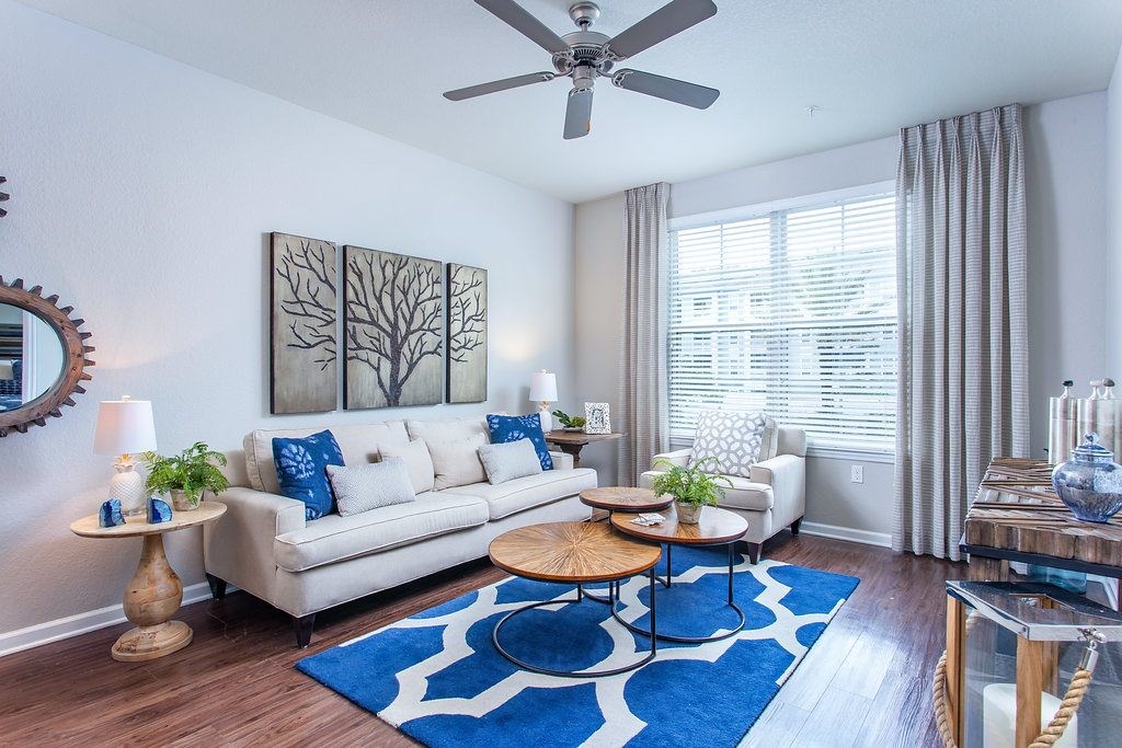a living room with a couch and a ceiling fan