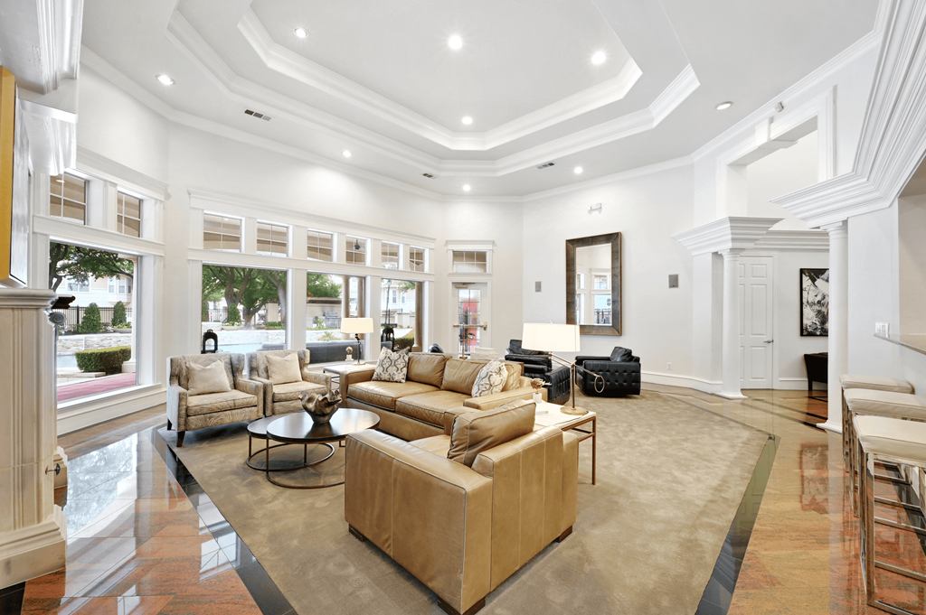 the living room has a coffered ceiling and large windows
