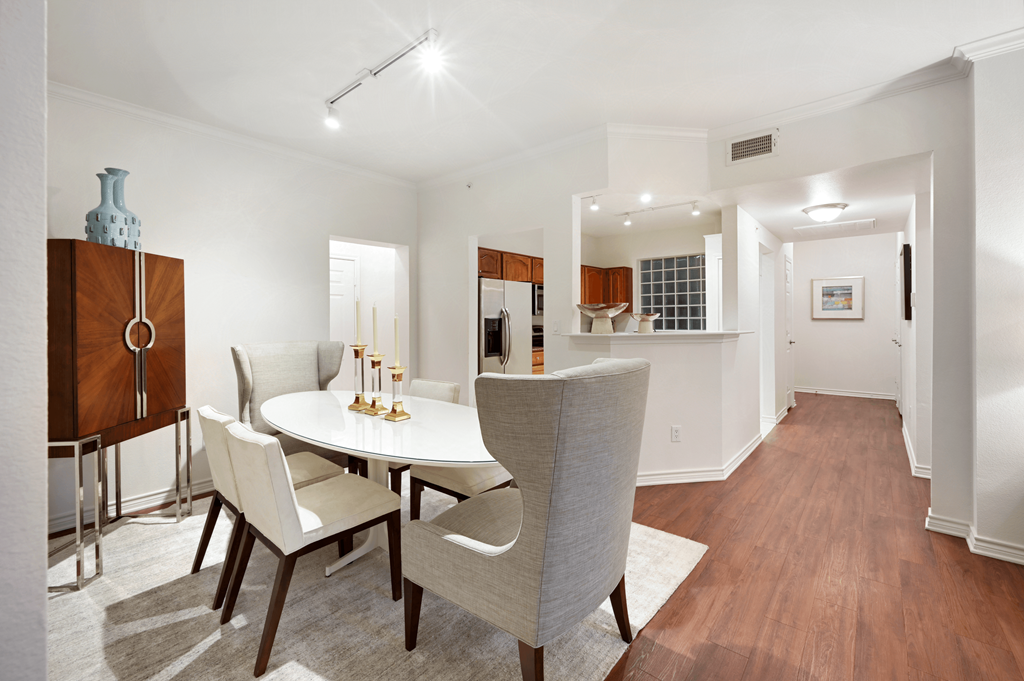 a dining room with a table and chairs and a kitchen