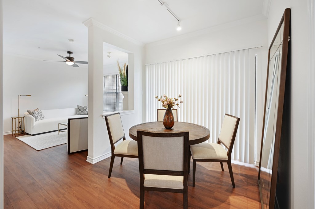 a living room and dining room with a table and chairs