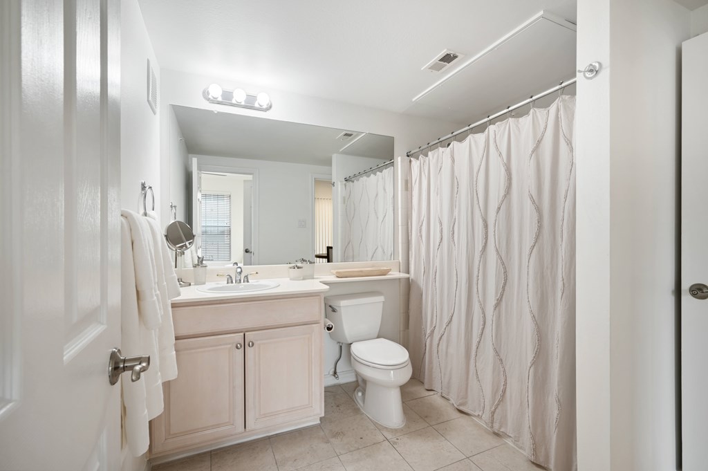 a bathroom with a sink toilet and a shower