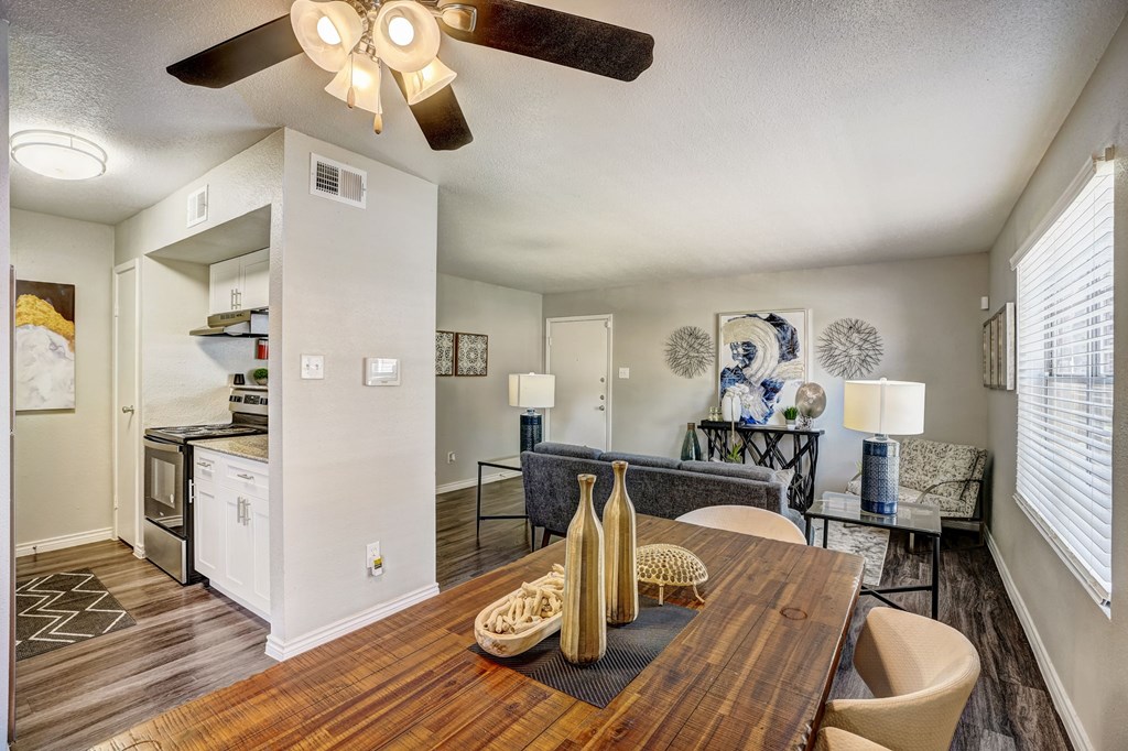 an open living room and dining room with a wooden table
