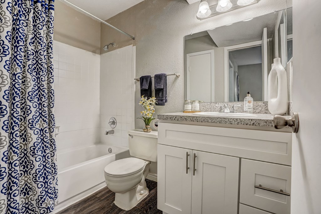 a white bathroom with a shower and a toilet