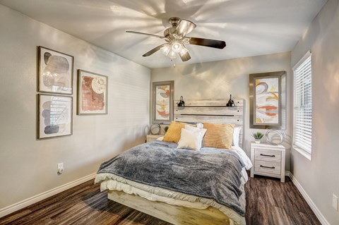 a bedroom with a bed and a ceiling fan