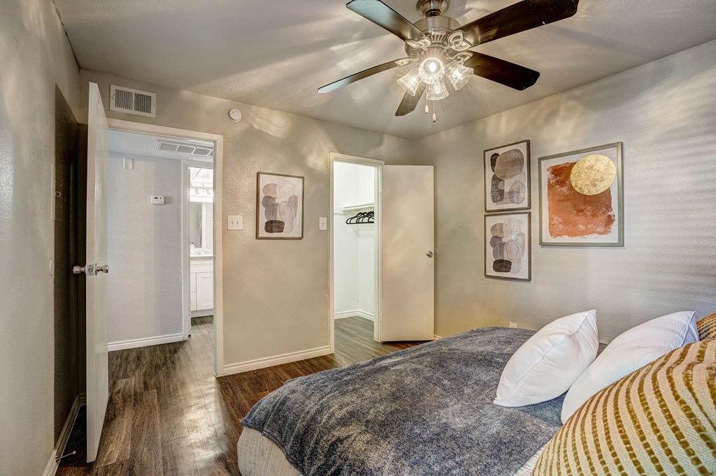 a bedroom with a bed and a ceiling fan